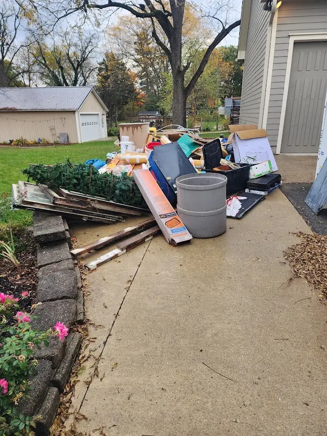 Dumpster being loaded with debris for Roofing Dumpster Rental in Plainfield